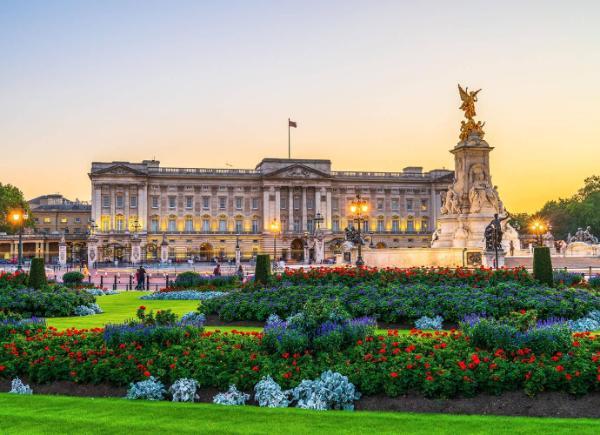Buckingham Palace with lush green gardens at sunset