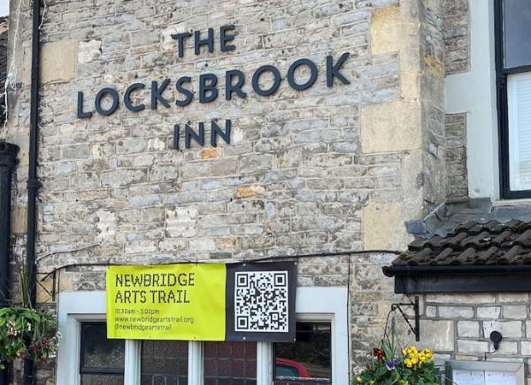 The exterior of a pub with a Newbridge Arts Trail sign