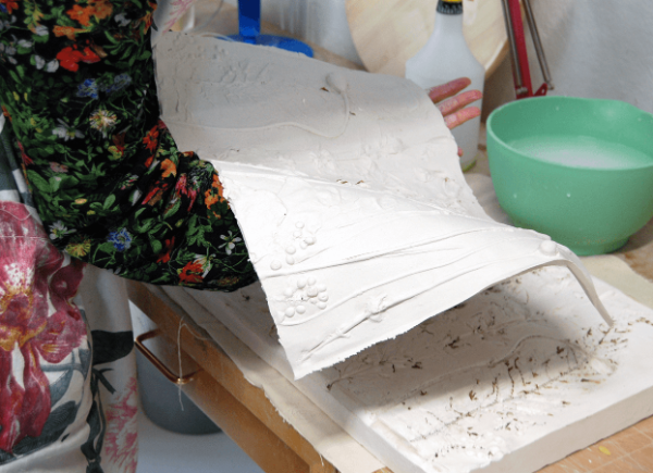 Woman with clay mould